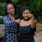 Home Two friends having fun and laughing outdoors in Nairobi, Kenya. A genuine moment of joy and togetherness.